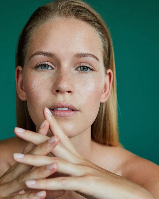 Close up of a young woman with open hair and natural complexion