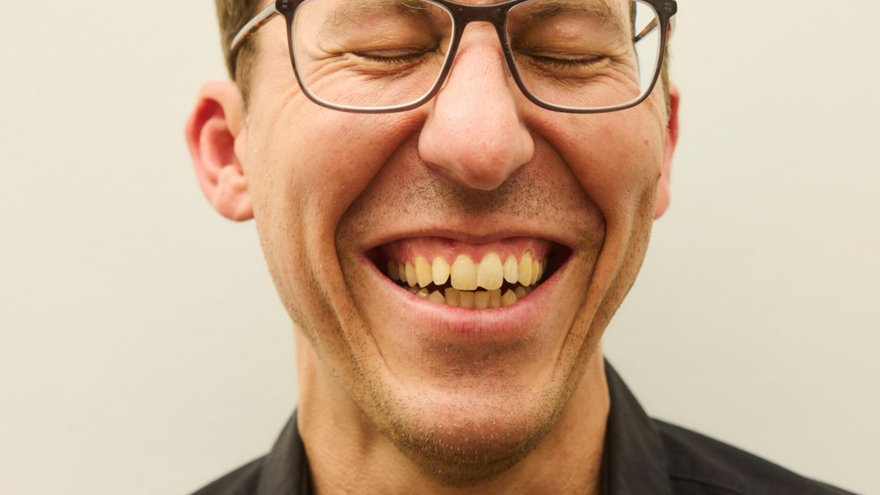Close-up of a smiling man with glasses, his eyes closed Close-up of a smiling man with glasses, his eyes closed