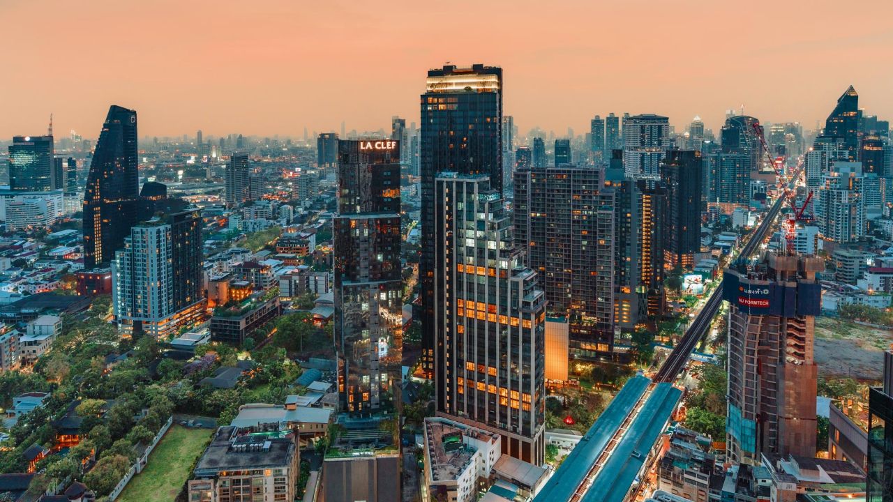 Aerial view shows the dense skyline of Bangkok at sunset with a BTS Skytrain Aerial view shows the dense skyline of Bangkok at sunset with a BTS Skytrain